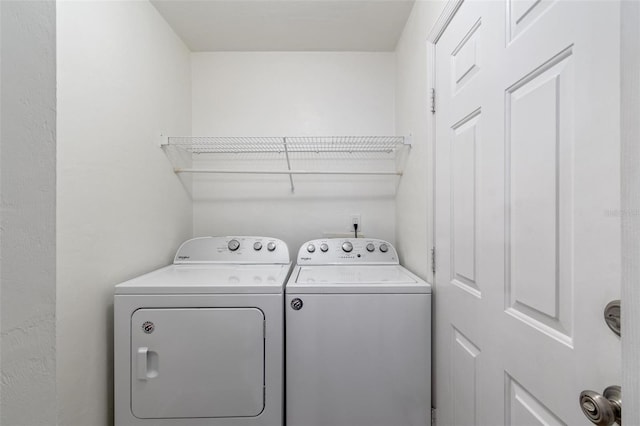 clothes washing area featuring washing machine and dryer