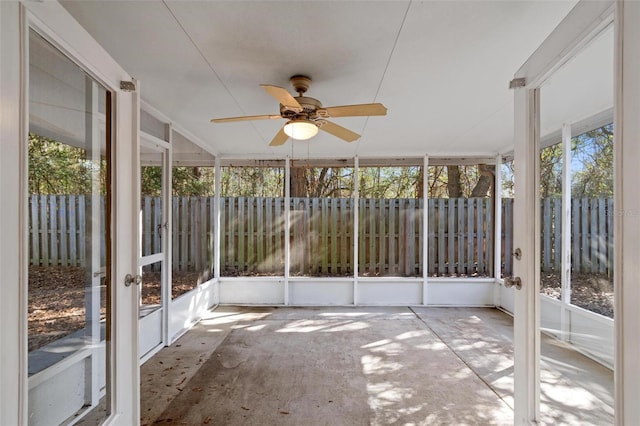 unfurnished sunroom featuring ceiling fan