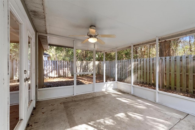 unfurnished sunroom featuring ceiling fan