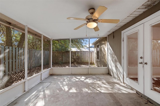 unfurnished sunroom with ceiling fan and french doors