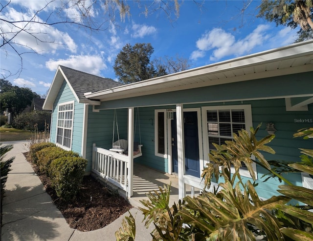 view of property exterior with a porch