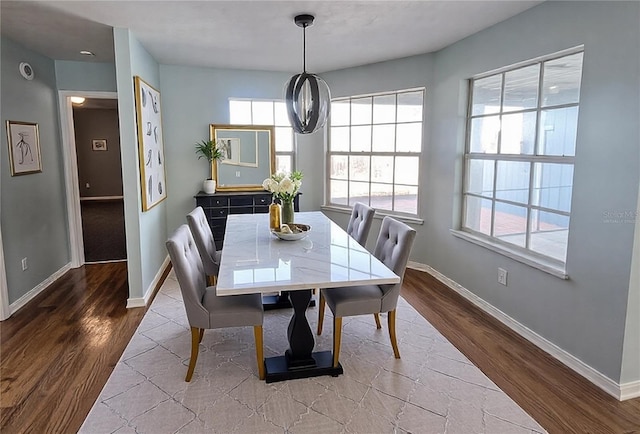 dining space featuring wood-type flooring