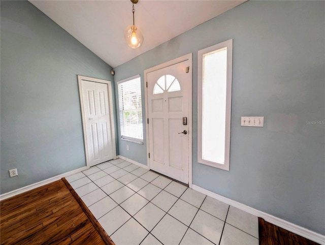 tiled foyer with lofted ceiling