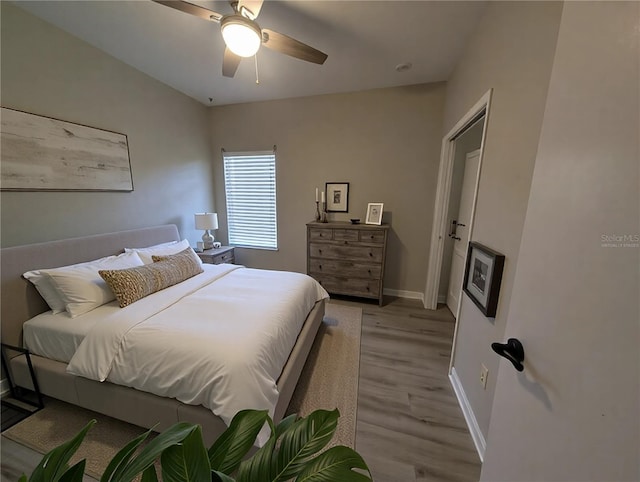 bedroom with ceiling fan and light hardwood / wood-style floors