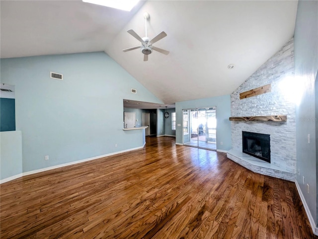 unfurnished living room featuring vaulted ceiling, hardwood / wood-style floors, ceiling fan, and a fireplace