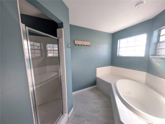 bathroom featuring separate shower and tub