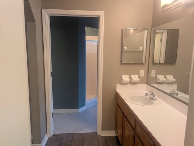 bathroom featuring vanity, hardwood / wood-style flooring, and walk in shower