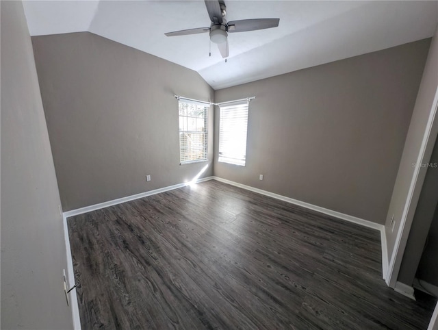 spare room featuring ceiling fan, lofted ceiling, and dark hardwood / wood-style flooring