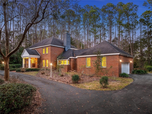 property exterior at dusk featuring a garage