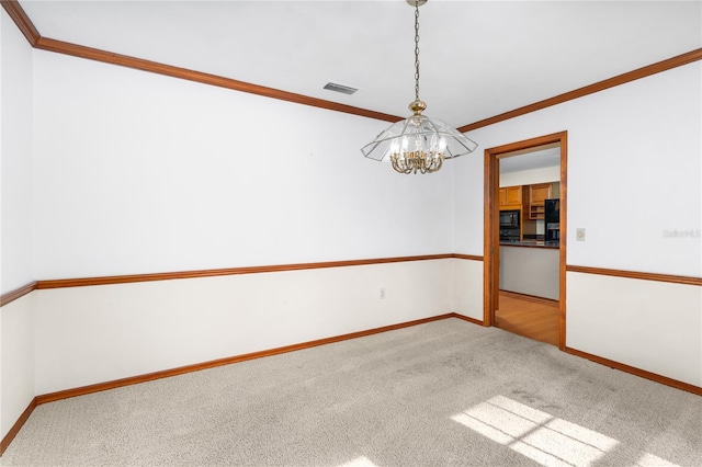 unfurnished room with ornamental molding, carpet floors, and a notable chandelier