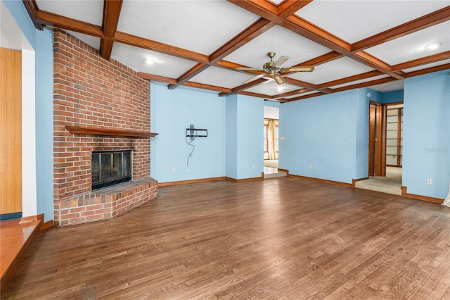 unfurnished living room featuring coffered ceiling, a brick fireplace, hardwood / wood-style flooring, and beamed ceiling