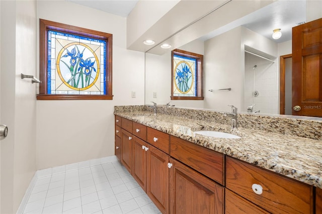 bathroom with vanity, tile patterned flooring, and walk in shower