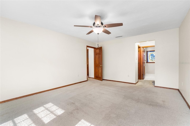 carpeted empty room featuring ceiling fan