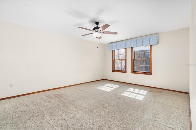 empty room featuring ceiling fan and carpet