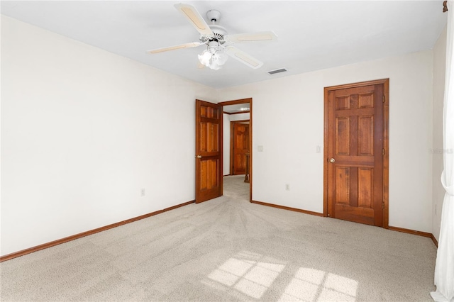 unfurnished bedroom featuring ceiling fan and light carpet