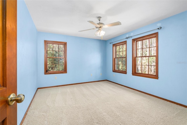 unfurnished room with ceiling fan, carpet floors, and a healthy amount of sunlight