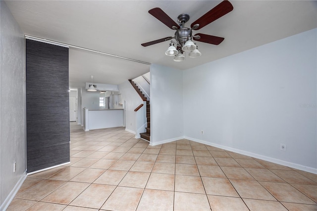 unfurnished living room with light tile patterned floors and ceiling fan