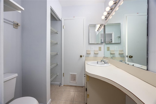 bathroom with vanity, tile patterned floors, and toilet