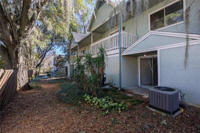 view of yard featuring a balcony and central air condition unit