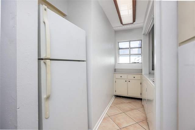 kitchen featuring light tile patterned floors and white refrigerator