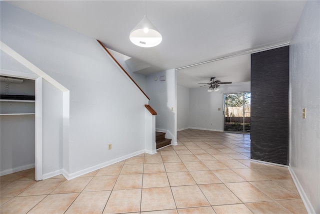 interior space with light tile patterned floors and ceiling fan