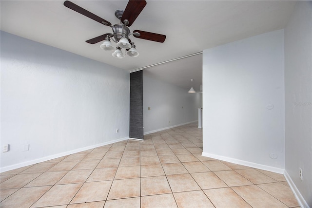 spare room with light tile patterned flooring and ceiling fan