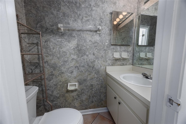 bathroom with tile patterned flooring, vanity, and toilet