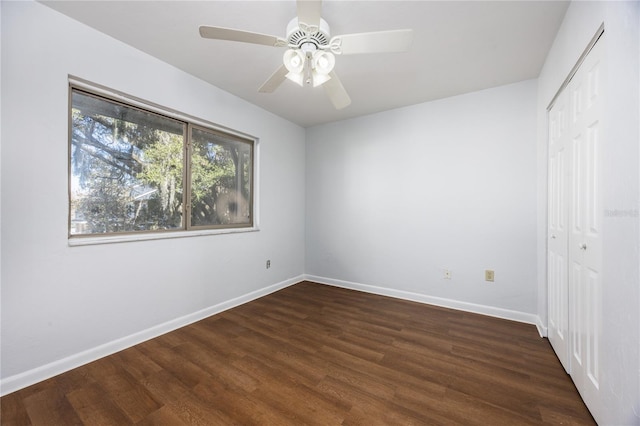 unfurnished bedroom featuring dark wood-type flooring, ceiling fan, and a closet