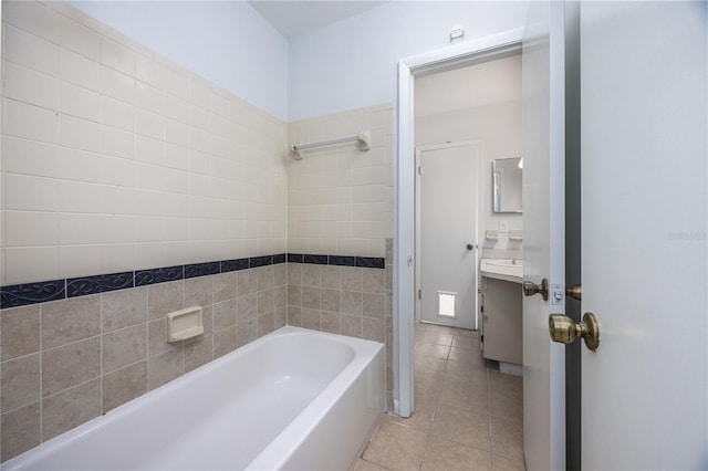 bathroom featuring vanity, a tub, and tile patterned floors