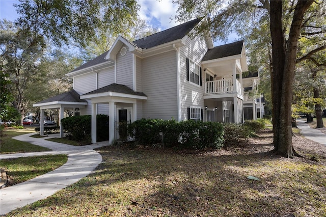 view of side of home featuring a balcony