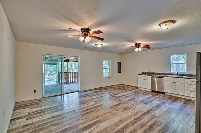 300 S US Highway 129, Bell, FL 32619 - kitchen with sink, white cabinetry, light hardwood / wood-style flooring, a textured ceiling, and stainless steel dishwasher