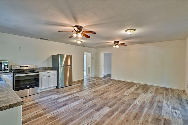 300 S US Highway 129, Bell, FL 32619 - kitchen featuring white cabinetry, stainless steel appliances, light hardwood / wood-style floors, and a textured ceiling