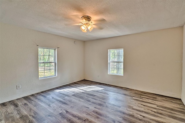 300 S US Highway 129, Bell, FL 32619 - spare room with hardwood / wood-style floors, a wealth of natural light, a textured ceiling, and ceiling fan