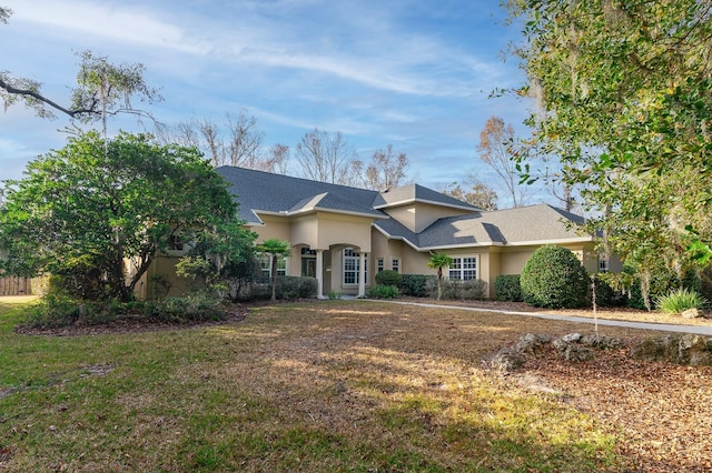 ranch-style home featuring a front yard