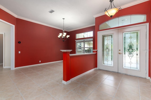 foyer entrance featuring ornamental molding, light tile patterned flooring, a notable chandelier, and french doors