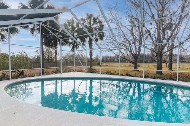 view of pool with glass enclosure