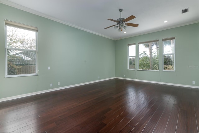 spare room featuring dark hardwood / wood-style flooring, crown molding, and ceiling fan