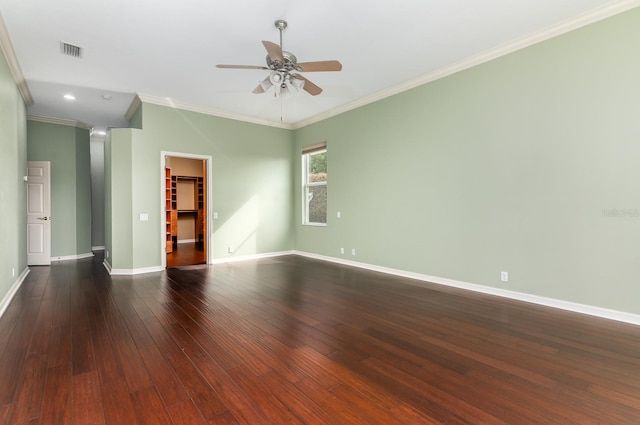 empty room with crown molding, dark hardwood / wood-style floors, and ceiling fan