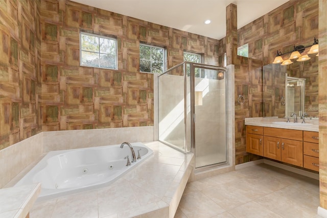 bathroom featuring vanity, independent shower and bath, tile patterned flooring, and tile walls