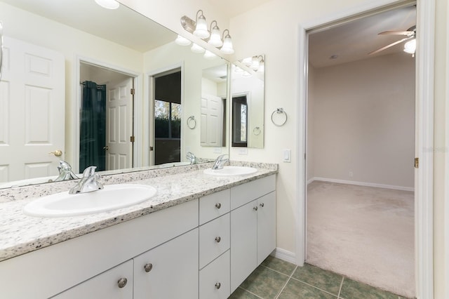 bathroom featuring ceiling fan, tile patterned floors, and vanity