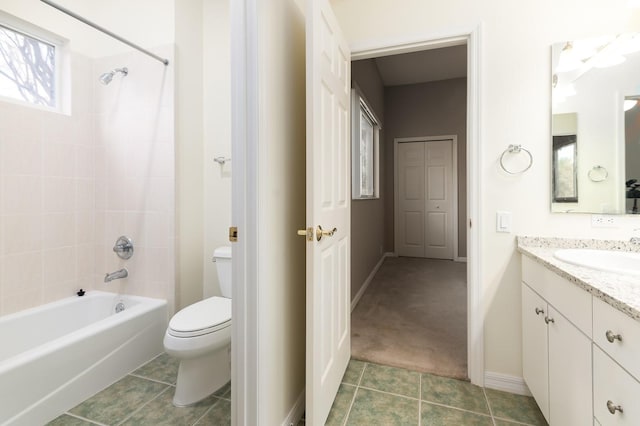 full bathroom featuring tiled shower / bath, vanity, toilet, and tile patterned flooring