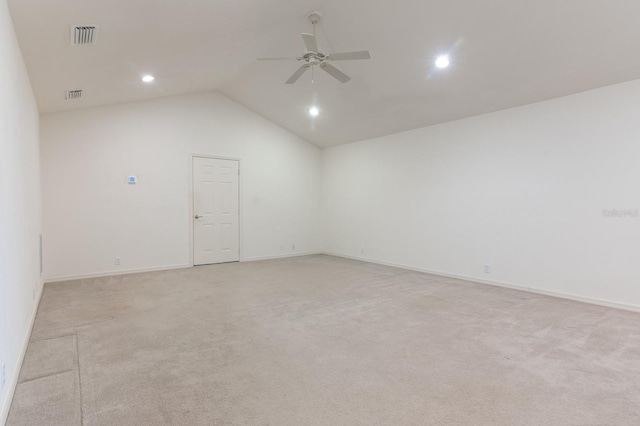 spare room with high vaulted ceiling, light colored carpet, and ceiling fan