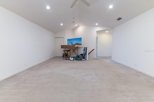 unfurnished office with ceiling fan, vaulted ceiling, and light carpet