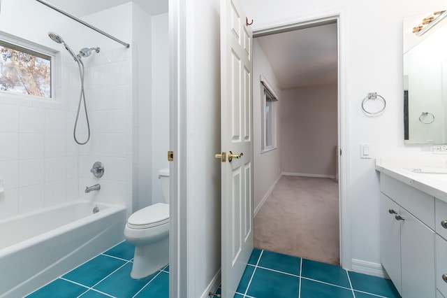 full bathroom featuring vanity, tiled shower / bath combo, tile patterned floors, and toilet