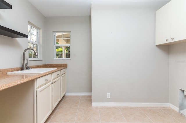 laundry room with sink and light tile patterned floors