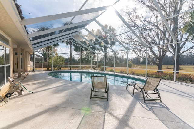 view of swimming pool with a lanai and a patio