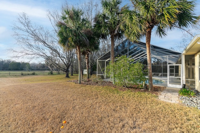 view of yard featuring glass enclosure