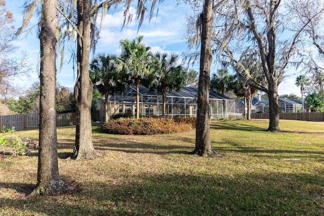 view of yard featuring glass enclosure