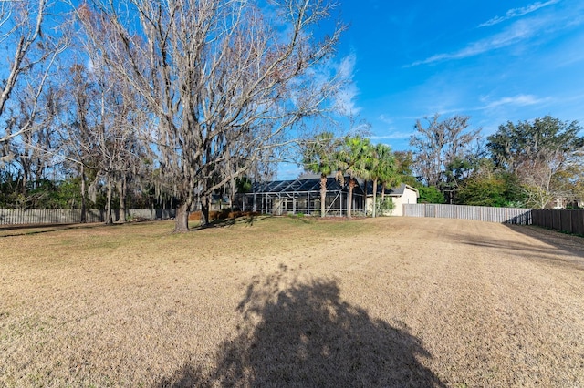 view of yard with glass enclosure