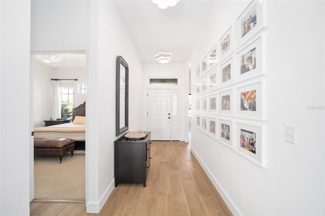 hallway with light hardwood / wood-style floors